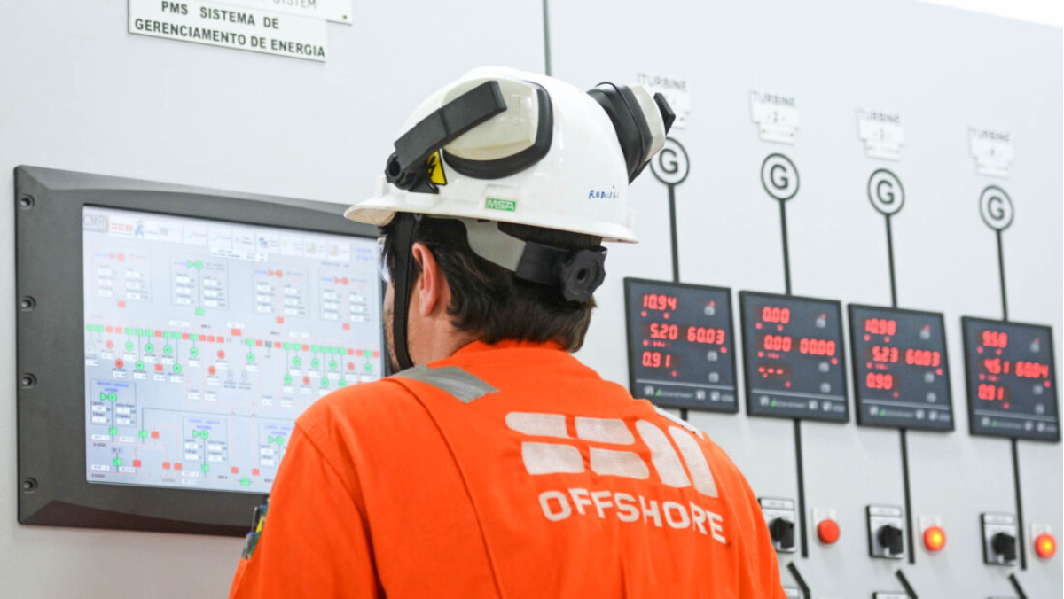 Offshore technician monitoring digital control systems for FPSO operations